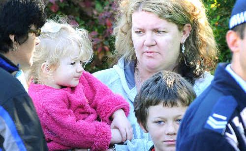 South Lismore mother Renee Devine with two of her seven children after fire destroyed their rented home in Cromer Street. South Lismore mother Renee Devine with two of her seven children after fire destroyed their rented home in Cromer Street.